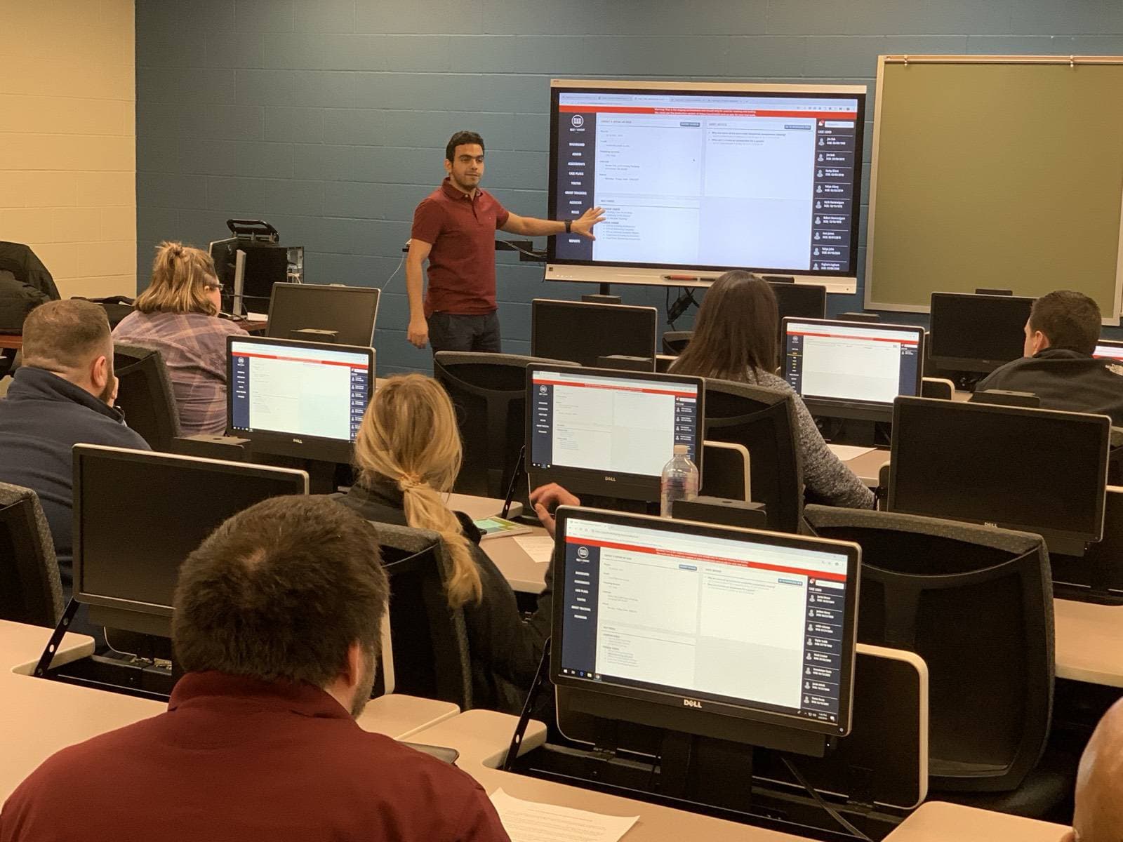 Yahya teaching a class in a computer lab